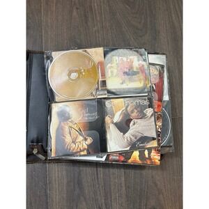 Y2K R&B  portable CD binder or case filled with various music CDs.